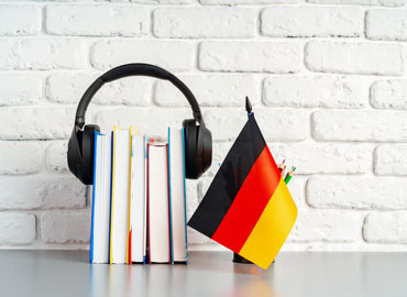 stack-books-flag-germany-desk-german-language-learning-concept_93675-157480